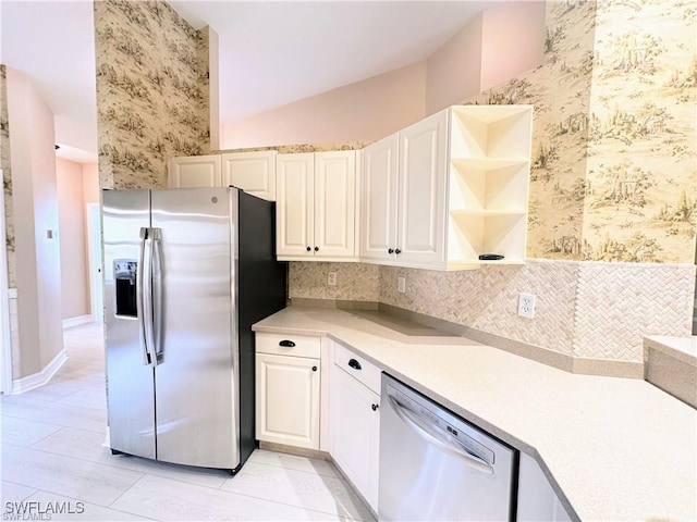 8088 Sanctuary Dr Unit 1, Naples, FL 34104 - kitchen with appliances with stainless steel finishes, light countertops, white cabinetry, and wallpapered walls