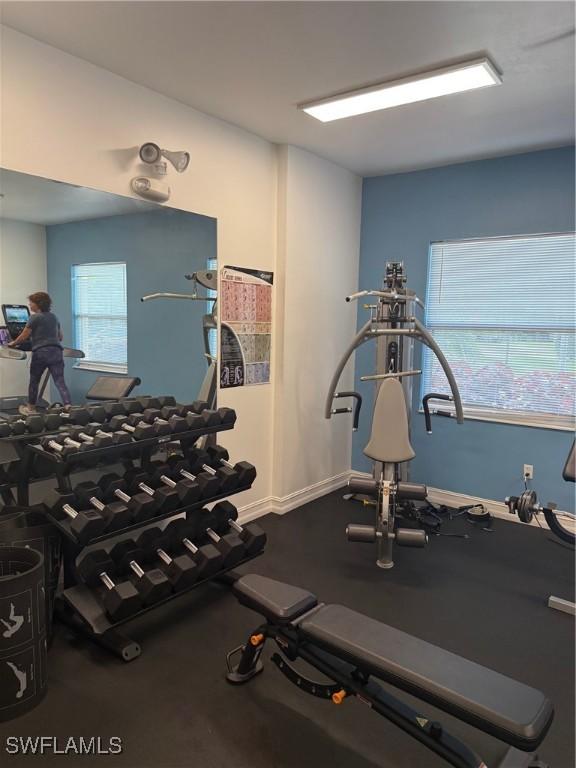 8088 Sanctuary Dr Unit 1, Naples, FL 34104 - exercise room with baseboards