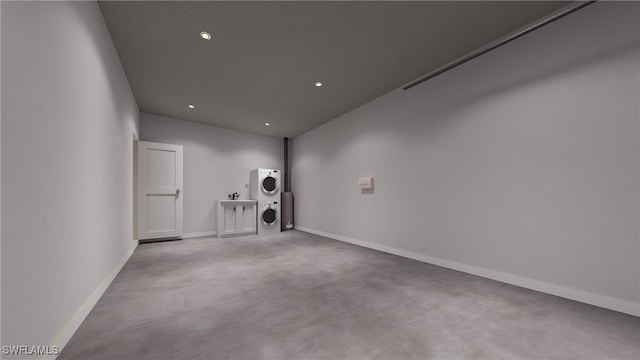 1075 Barnett St E, Lehigh Acres, FL 33974 - empty room with stacked washer and clothes dryer, finished concrete flooring, and recessed lighting