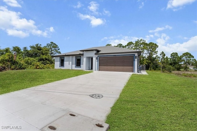 1032 Maxwell Ave S, Lehigh Acres, FL 33974 - prairie-style house with a front lawn, a garage, driveway, stucco siding, and a shingled roof