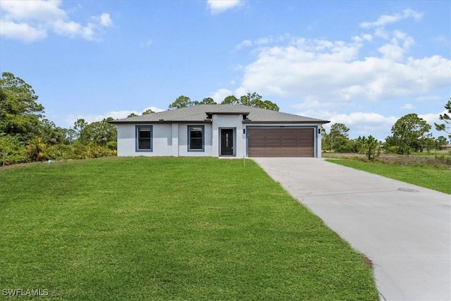 1032 Maxwell Ave S, Lehigh Acres, FL 33974 - prairie-style home with concrete driveway, stucco siding, a garage, and a front yard