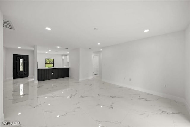 1032 Maxwell Ave S, Lehigh Acres, FL 33974 - unfurnished living room with recessed lighting, baseboards, and light marble finish floors