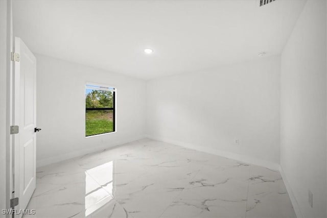 1032 Maxwell Ave S, Lehigh Acres, FL 33974 - spare room with marble finish floors, baseboards, and recessed lighting