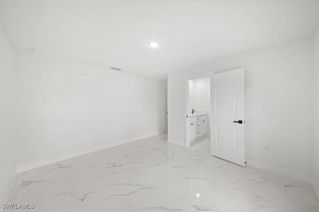 1032 Maxwell Ave S, Lehigh Acres, FL 33974 - empty room featuring baseboards, light marble finish floors, and recessed lighting