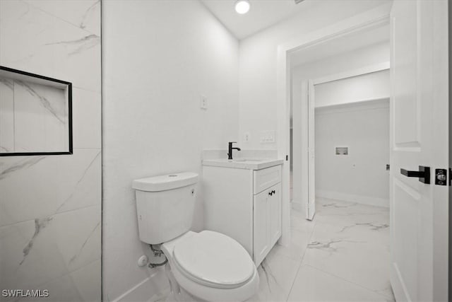 1032 Maxwell Ave S, Lehigh Acres, FL 33974 - bathroom with marble look tiles, vanity, toilet, and baseboards