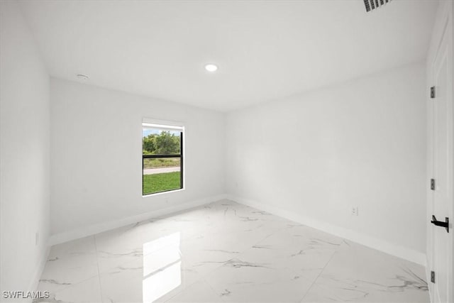 1032 Maxwell Ave S, Lehigh Acres, FL 33974 - spare room featuring marble finish flooring, baseboards, and recessed lighting
