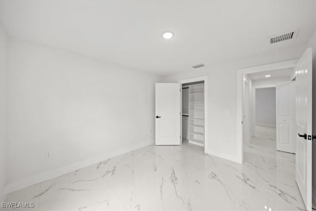 1032 Maxwell Ave S, Lehigh Acres, FL 33974 - unfurnished bedroom featuring baseboards, light marble finish floors, recessed lighting, and a closet