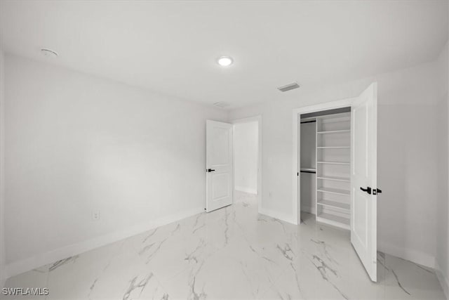1032 Maxwell Ave S, Lehigh Acres, FL 33974 - unfurnished bedroom featuring baseboards, marble look tiles, recessed lighting, and a closet