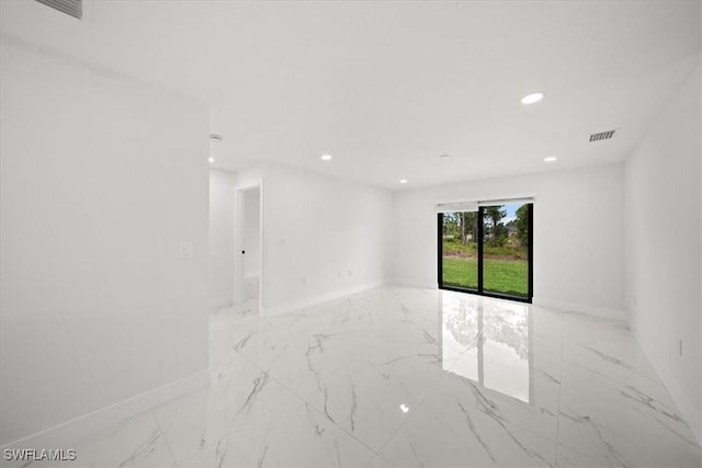 1032 Maxwell Ave S, Lehigh Acres, FL 33974 - unfurnished room with marble finish flooring, baseboards, and recessed lighting