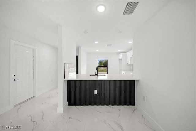 1032 Maxwell Ave S, Lehigh Acres, FL 33974 - kitchen featuring light marble finish flooring, a sink, white cabinets, baseboards, and recessed lighting