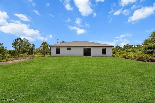 1032 Maxwell Ave S, Lehigh Acres, FL 33974 - rear view of house featuring a yard and stucco siding