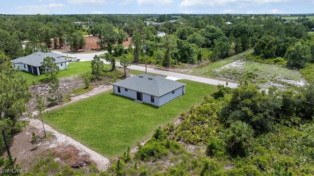 1032 Maxwell Ave S, Lehigh Acres, FL 33974 - view from above of property with a heavily wooded area