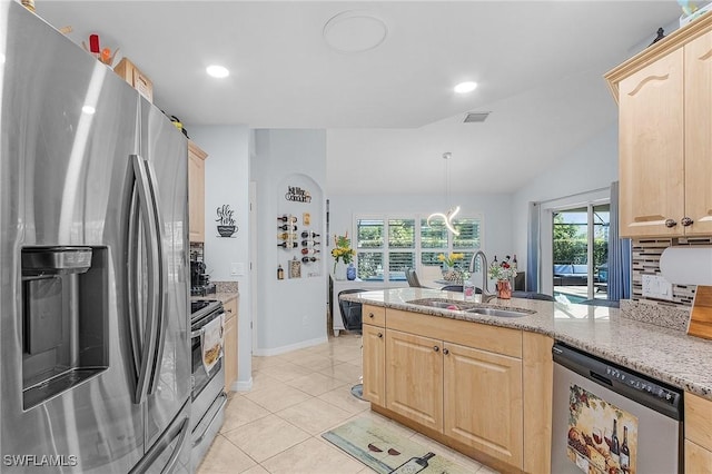 907 SE 19th Ter, Cape Coral, FL 33990 - kitchen with stainless steel appliances, light brown cabinets, a peninsula, light stone counters, and light tile patterned floors