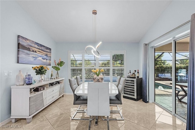 907 SE 19th Ter, Cape Coral, FL 33990 - dining room featuring lofted ceiling, healthy amount of natural light, a chandelier, wine cooler, and light tile patterned floors