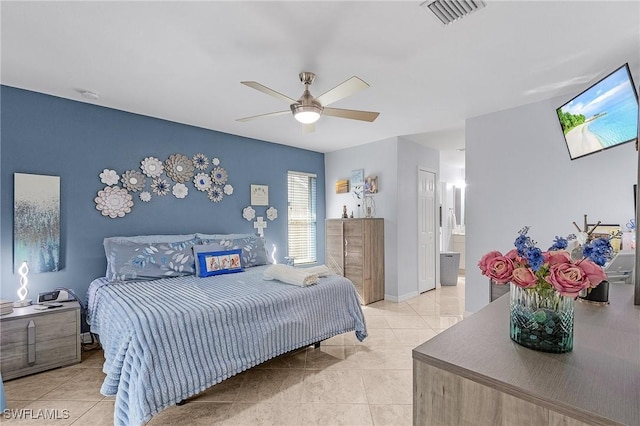 907 SE 19th Ter, Cape Coral, FL 33990 - bedroom featuring light tile patterned floors, a ceiling fan, and ensuite bathroom