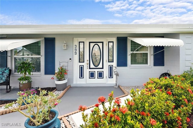 399 Grenier Dr, North Fort Myers, FL 33903 - doorway to property with a porch
