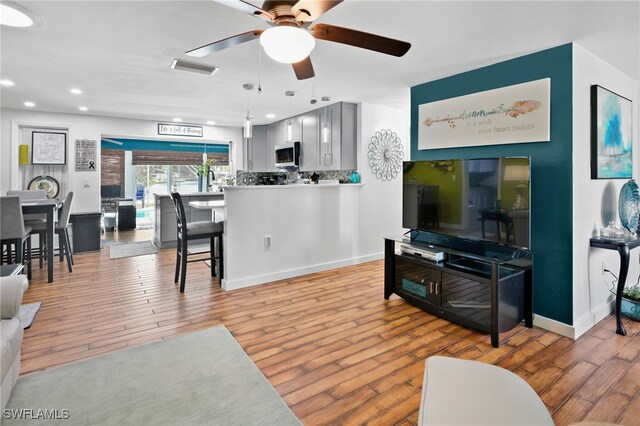 399 Grenier Dr, North Fort Myers, FL 33903 - living area featuring light wood finished floors, a ceiling fan, recessed lighting, and baseboards