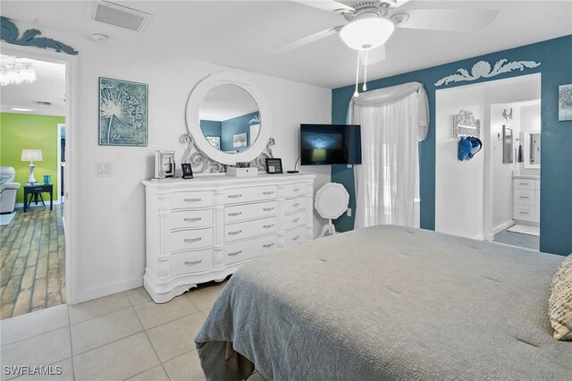 399 Grenier Dr, North Fort Myers, FL 33903 - bedroom featuring baseboards, light tile patterned floors, ceiling fan, and ensuite bath
