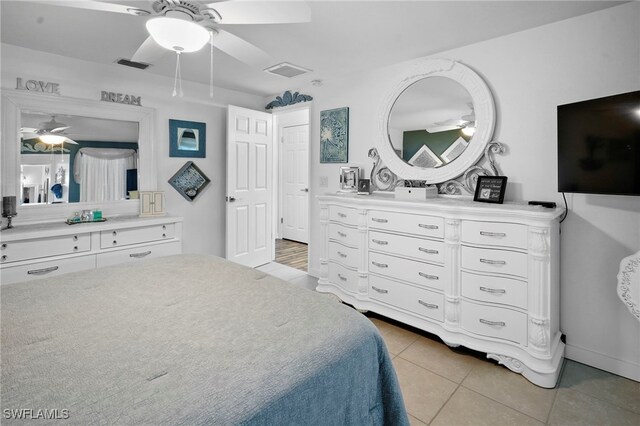 399 Grenier Dr, North Fort Myers, FL 33903 - bedroom featuring light tile patterned floors, a ceiling fan, and baseboards