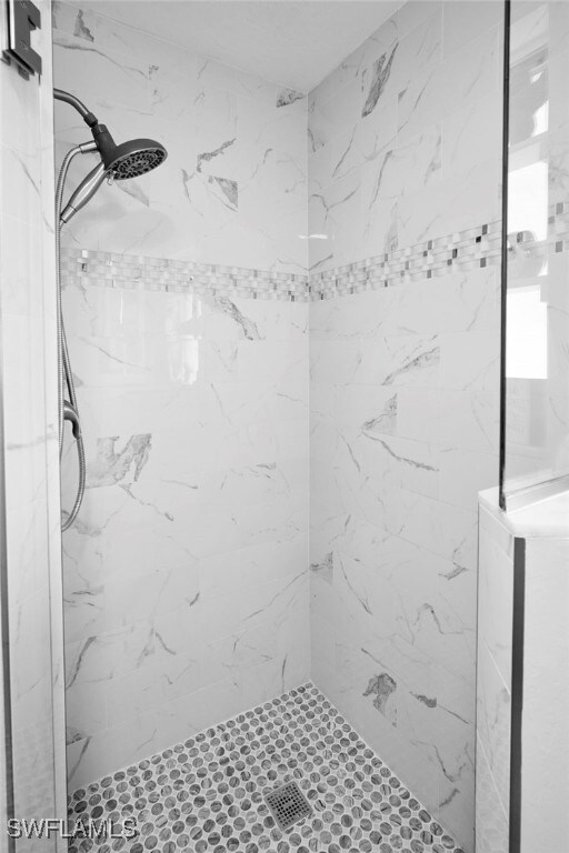 399 Grenier Dr, North Fort Myers, FL 33903 - bathroom with a marble finish shower