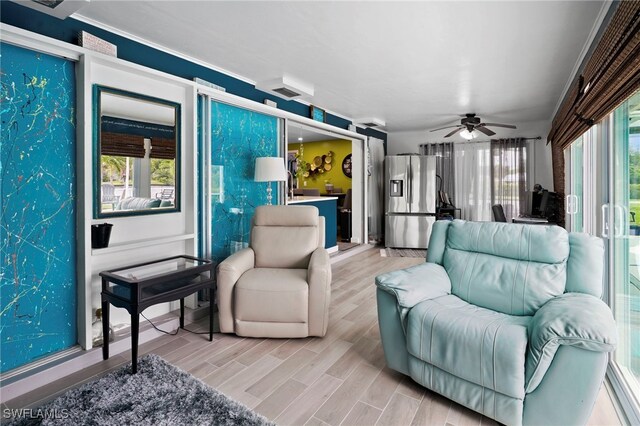 399 Grenier Dr, North Fort Myers, FL 33903 - living room with a ceiling fan and light wood-style flooring