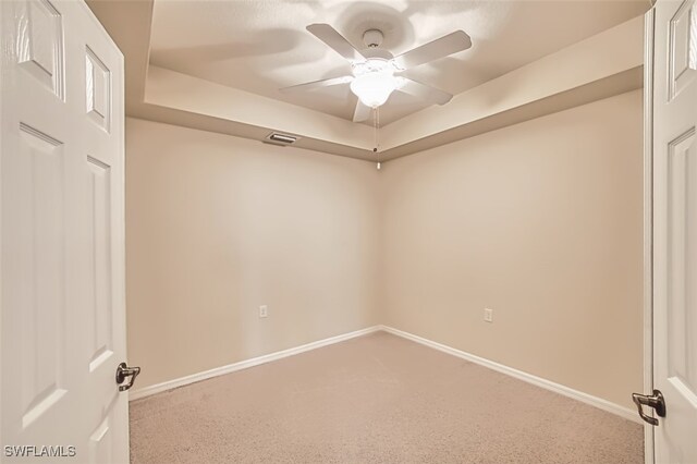 13751 Julias Way Unit 414, Fort Myers, FL 33919 - spare room featuring a ceiling fan, carpet, baseboards, and a tray ceiling