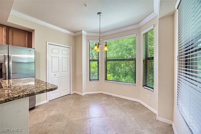 13751 Julias Way Unit 414, Fort Myers, FL 33919 - unfurnished dining area featuring a chandelier, crown molding, light tile patterned floors, and baseboards