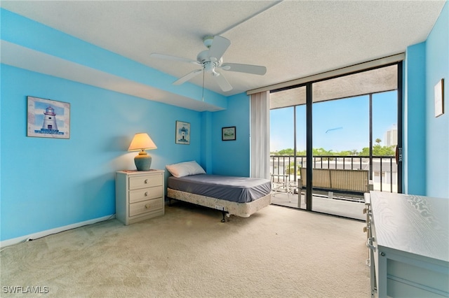 3460 N Key Dr Unit 409, North Fort Myers, FL 33903 - bedroom featuring a wall of windows, carpet, access to exterior, and a ceiling fan