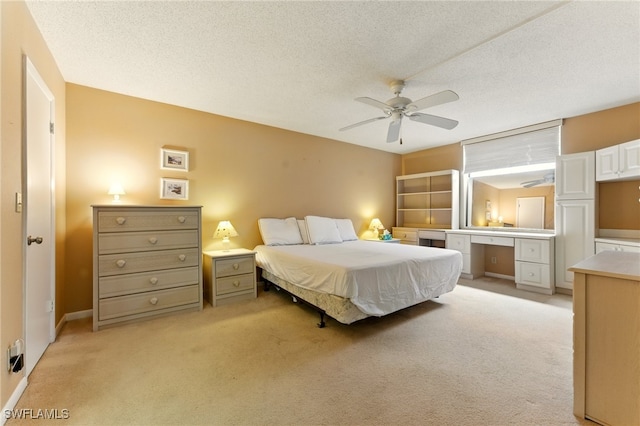 3460 N Key Dr Unit 409, North Fort Myers, FL 33903 - bedroom with light colored carpet, ceiling fan, a textured ceiling, and a desk