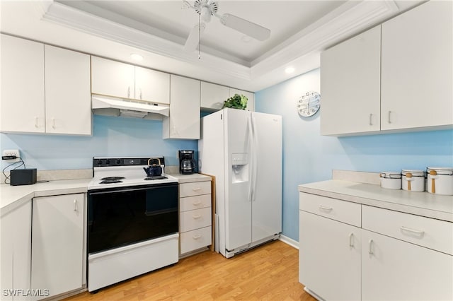 3460 N Key Dr Unit 409, North Fort Myers, FL 33903 - kitchen with under cabinet range hood, white refrigerator with ice dispenser, electric range, a tray ceiling, and light countertops