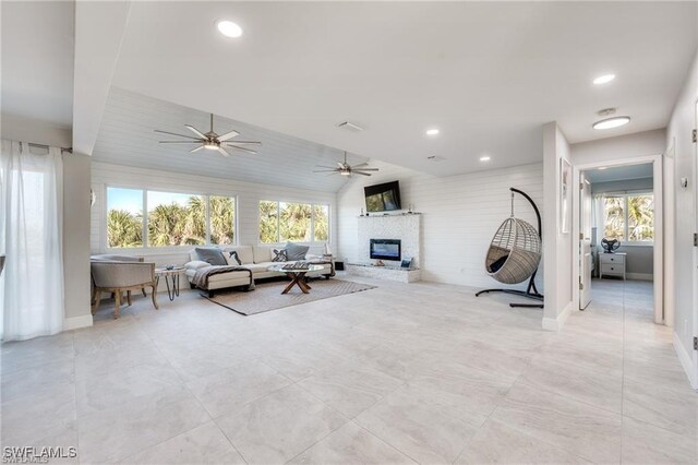 785 Rabbit Rd, Sanibel, FL 33957 - living room featuring a glass covered fireplace, ceiling fan, recessed lighting, baseboards, and lofted ceiling
