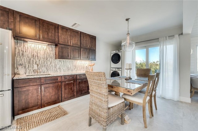 785 Rabbit Rd, Sanibel, FL 33957 - dining room featuring stacked washer / drying machine