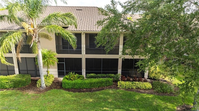 793 Regency Reserve Cir Unit 4501, Naples, FL 34119 - rear view of house featuring a lawn and a tile roof