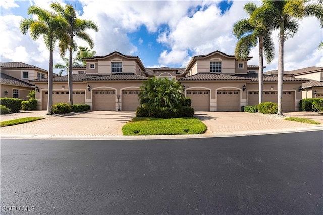 793 Regency Reserve Cir Unit 4501, Naples, FL 34119 - mediterranean / spanish-style house featuring driveway, stucco siding, a tiled roof, and an attached garage