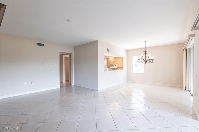 793 Regency Reserve Cir Unit 4501, Naples, FL 34119 - unfurnished room with a chandelier and light tile patterned floors