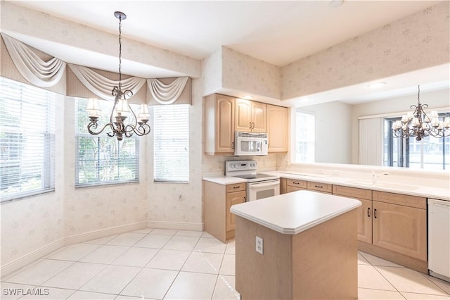 793 Regency Reserve Cir Unit 4501, Naples, FL 34119 - kitchen featuring white appliances, a chandelier, light brown cabinetry, wallpapered walls, and light tile patterned flooring