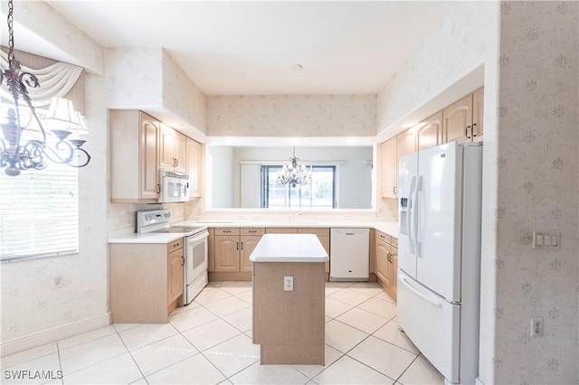 793 Regency Reserve Cir Unit 4501, Naples, FL 34119 - kitchen with white appliances, light brown cabinetry, wallpapered walls, a chandelier, and a kitchen island