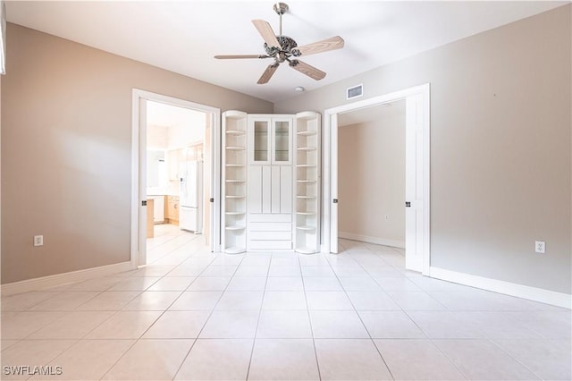 793 Regency Reserve Cir Unit 4501, Naples, FL 34119 - unfurnished bedroom featuring white refrigerator with ice dispenser, light tile patterned floors, and a ceiling fan