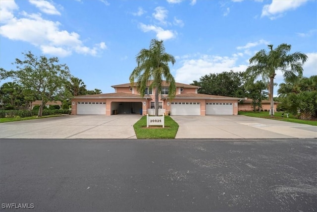 20025 Lake Vista Cir Unit 6B, Lehigh Acres, FL 33936 - view of front facade featuring driveway, stucco siding, and a garage