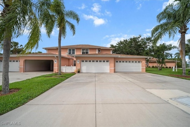 20025 Lake Vista Cir Unit 6B, Lehigh Acres, FL 33936 - traditional-style house with stucco siding, driveway, and an attached garage