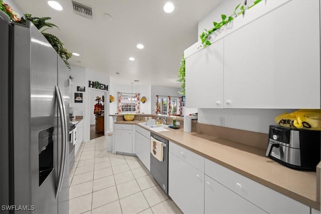 20025 Lake Vista Cir Unit 6B, Lehigh Acres, FL 33936 - kitchen featuring stainless steel appliances, white cabinetry, a sink, a peninsula, and recessed lighting