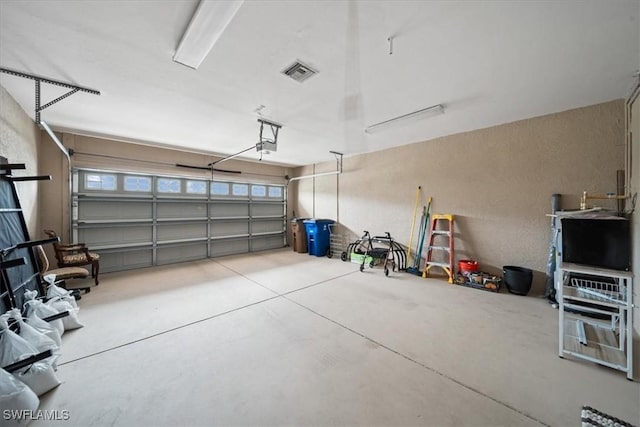 20025 Lake Vista Cir Unit 6B, Lehigh Acres, FL 33936 - garage with a textured wall and a garage door opener