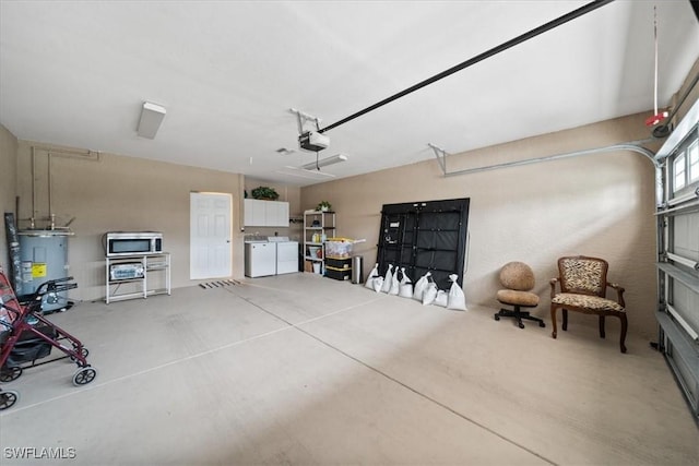 20025 Lake Vista Cir Unit 6B, Lehigh Acres, FL 33936 - garage featuring washing machine and dryer, water heater, and a garage door opener