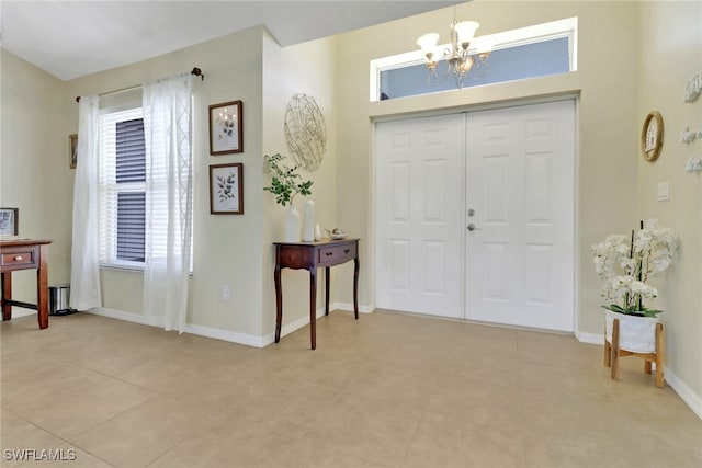 2223 SW 16th Ter, Cape Coral, FL 33991 - foyer entrance featuring a chandelier, light tile patterned flooring, and baseboards