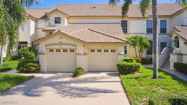 9110 Bayberry Bnd Unit 102, Fort Myers, FL 33908 - mediterranean / spanish house featuring a tile roof, concrete driveway, stucco siding, and an attached garage