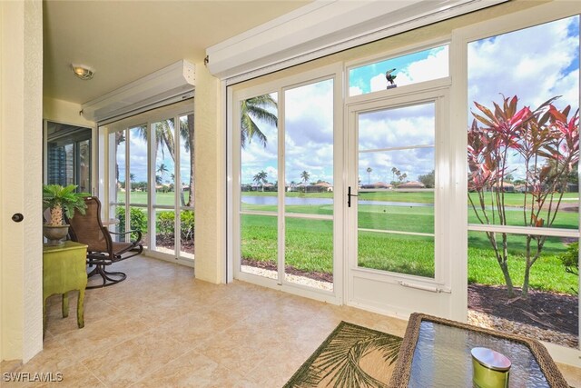 9110 Bayberry Bnd Unit 102, Fort Myers, FL 33908 - sunroom / solarium featuring a water view and tile patterned floors