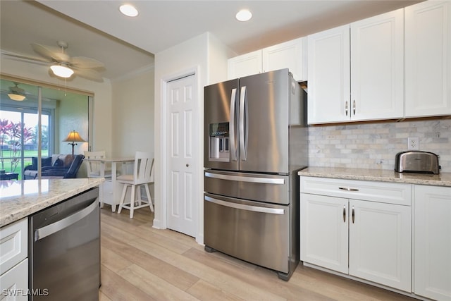 9110 Bayberry Bnd Unit 102, Fort Myers, FL 33908 - kitchen featuring appliances with stainless steel finishes, tasteful backsplash, light wood-type flooring, white cabinetry, and recessed lighting