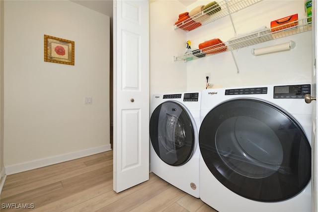 9110 Bayberry Bnd Unit 102, Fort Myers, FL 33908 - laundry room with washer and dryer, light wood finished floors, and baseboards