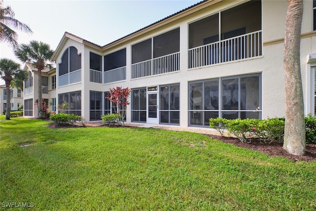 9110 Bayberry Bnd Unit 102, Fort Myers, FL 33908 - back of property featuring stucco siding and a lawn