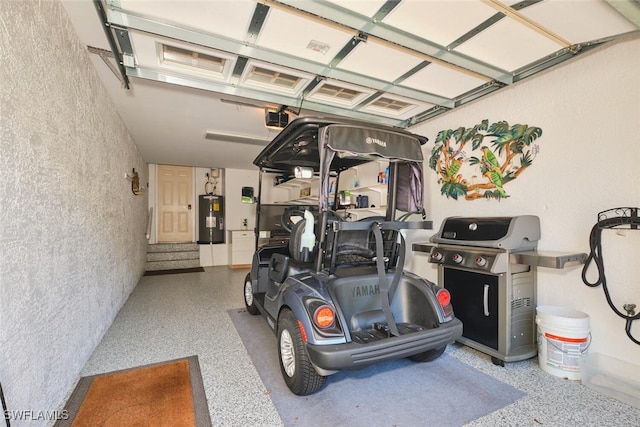 9110 Bayberry Bnd Unit 102, Fort Myers, FL 33908 - garage with water heater, a garage door opener, and a textured wall